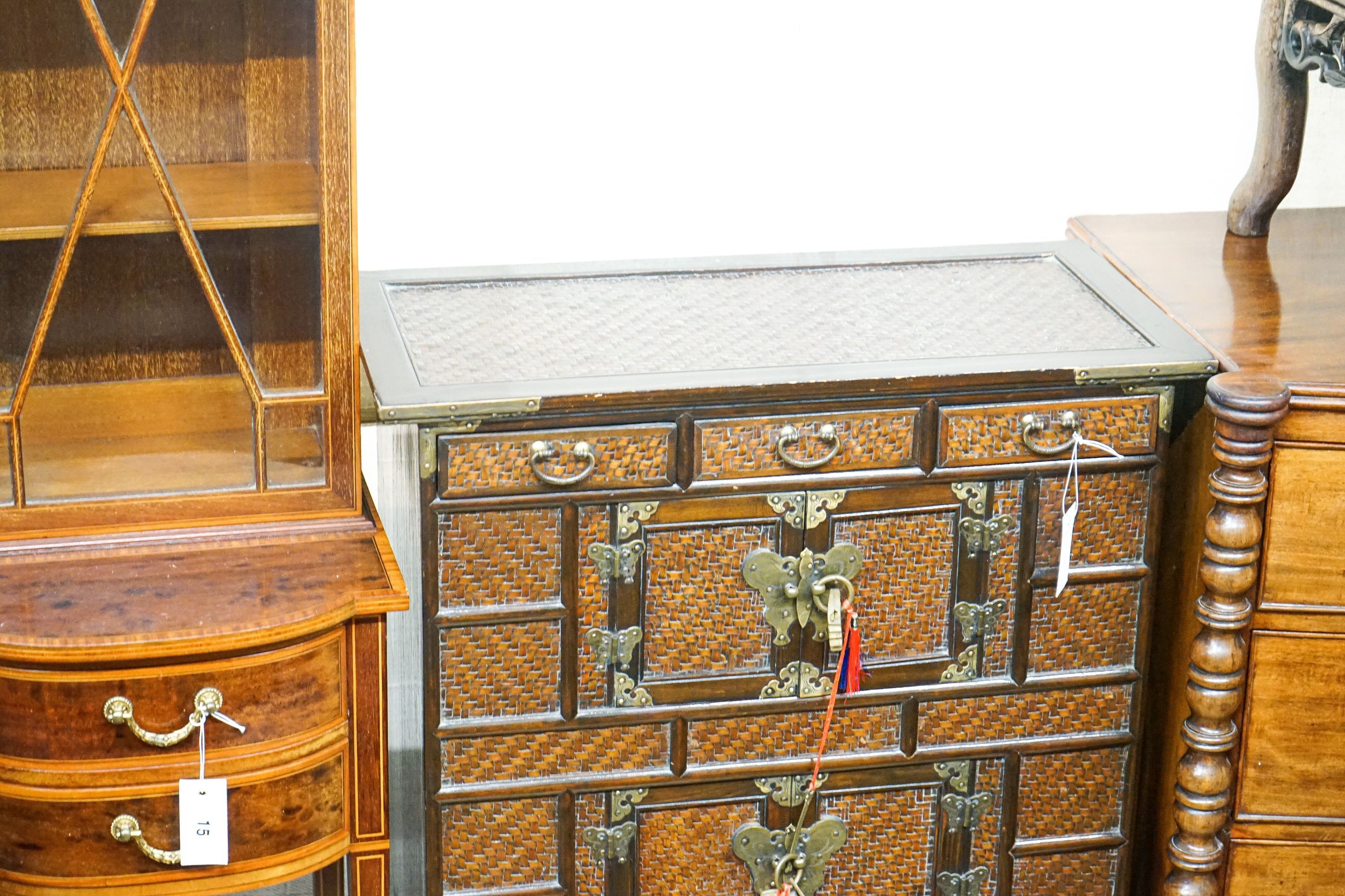 A 20th century Chinese stained wood and rattan side cabinet, width 67cm, depth 32cm, height 104cm